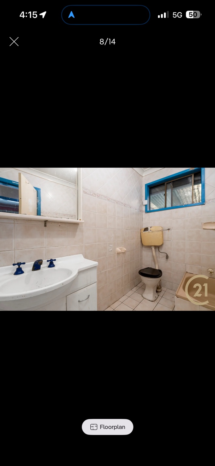 Ashcroft bathroom before renovation, with dated tiles, vanity and fixtures